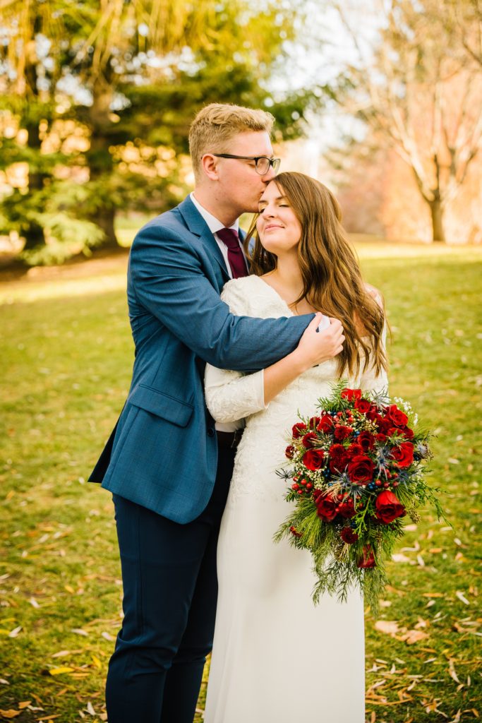 Jackson Hole wedding photographer captures newly married couple embracing while wearing wedding attire