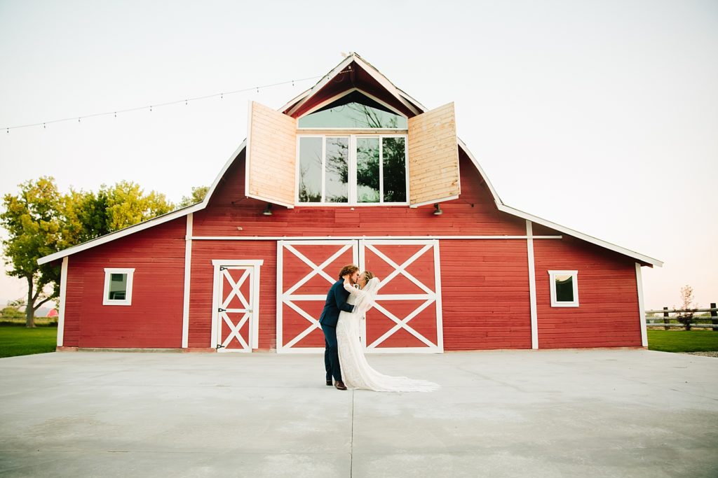 bride and groom kissing at red barn events top wedding venues in south east idaho