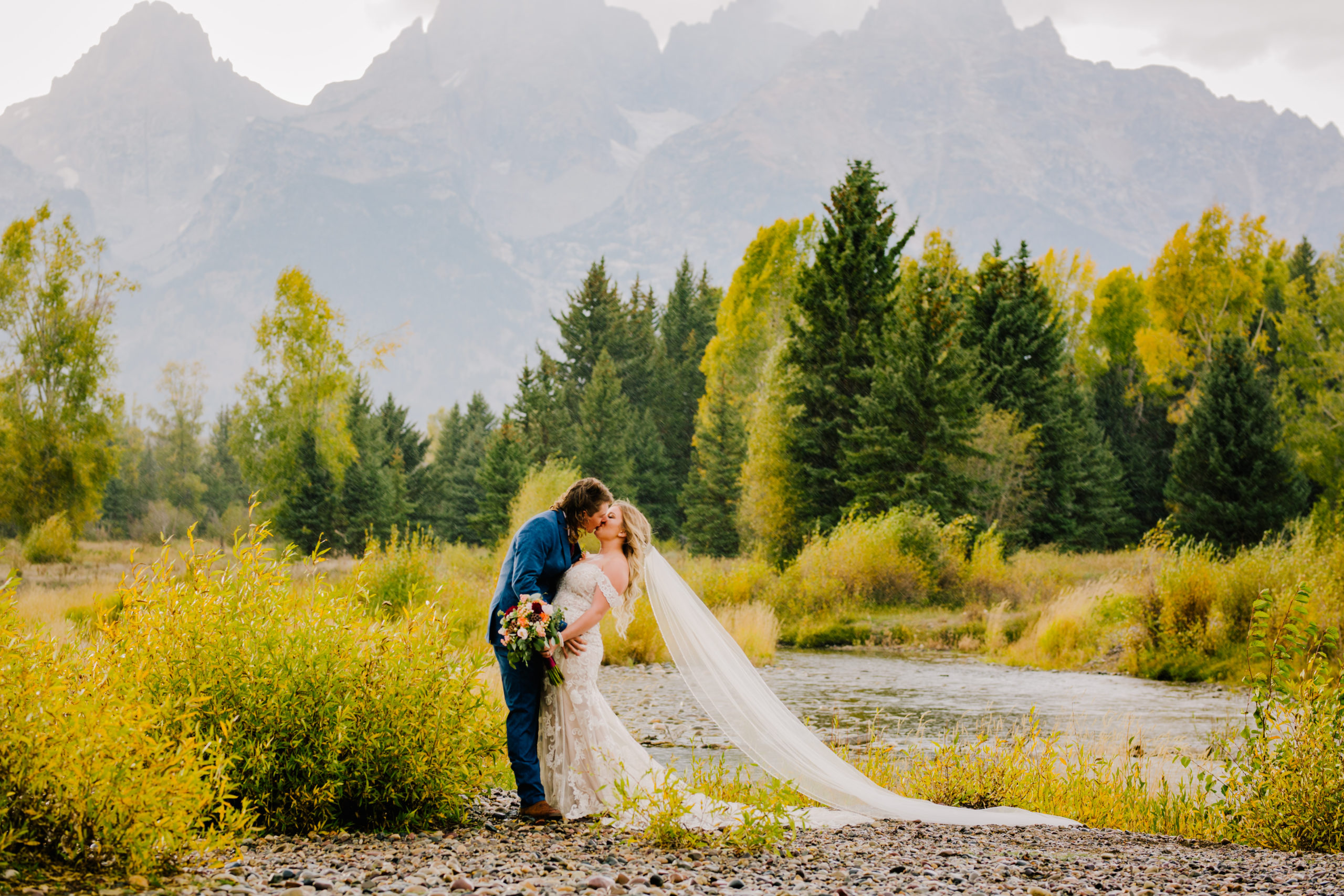Bride and groom kissing in grand Teton national park