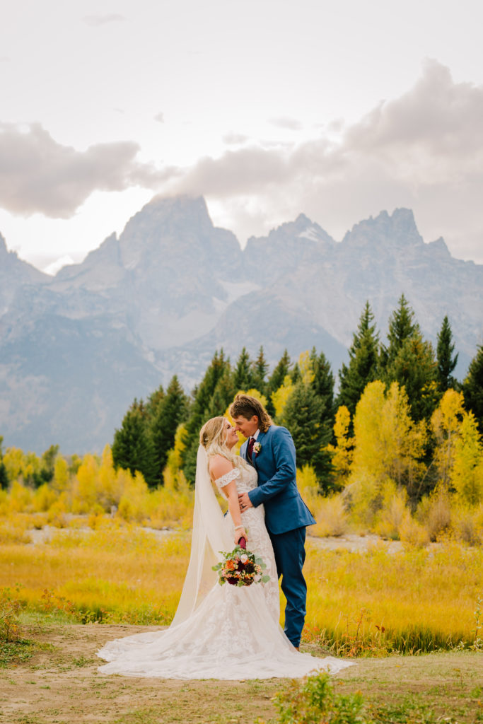 Jackson Hole wedding photographer captures bride and groom kissing in grand teton national park