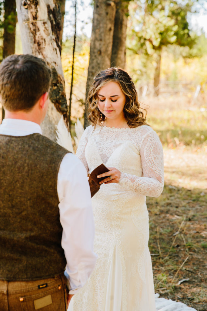 Jackson Hole wedding photographer captures bride reading vows to groom