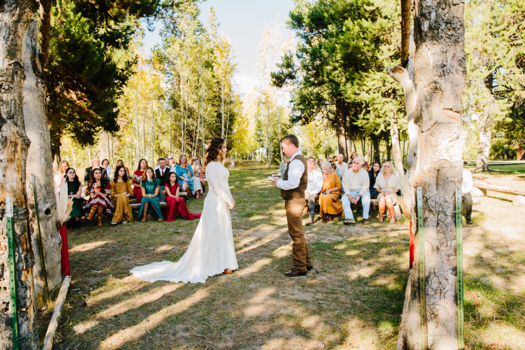Jackson Hole wedding photographer captures couple standing together during wedding ceremony