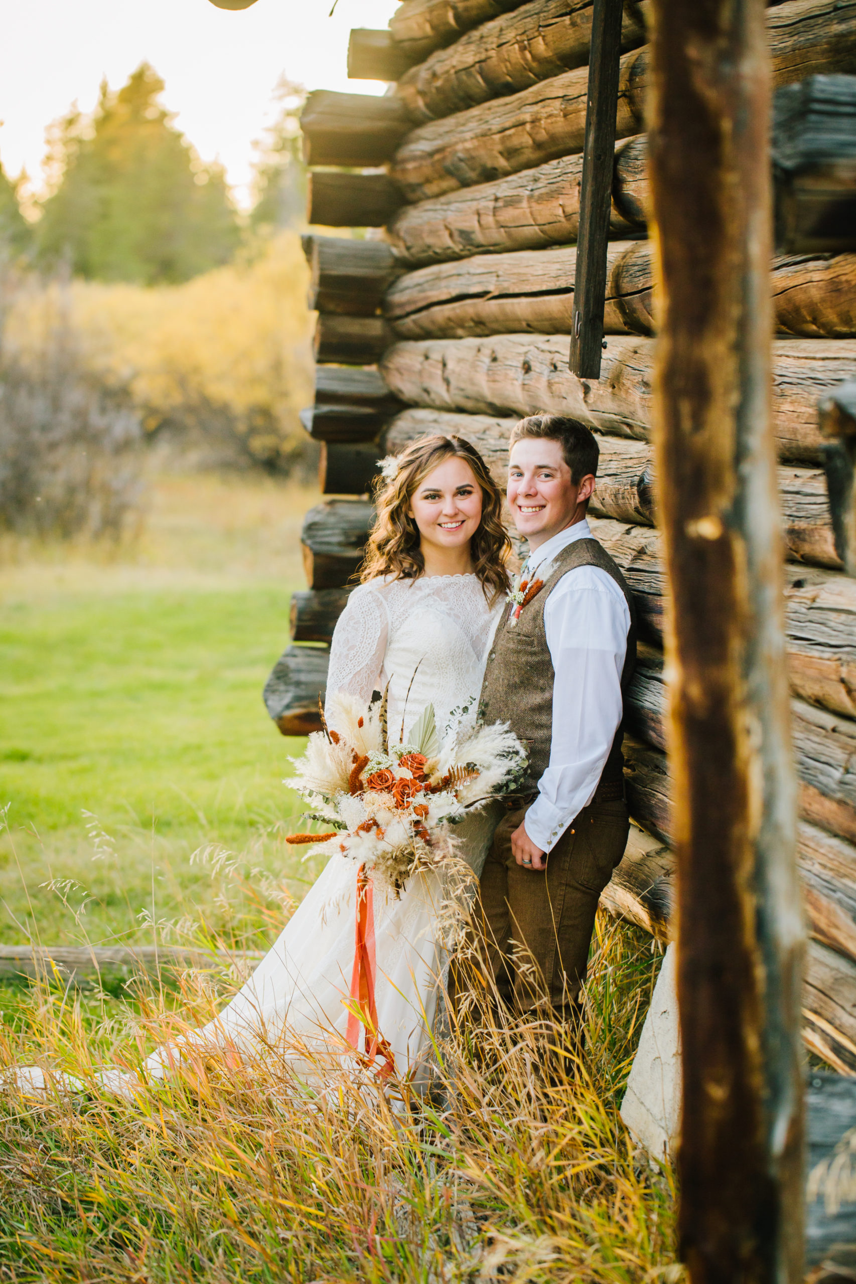 bride and groom standing together att their outdoor wedding venue in Yellowstone in the fall 