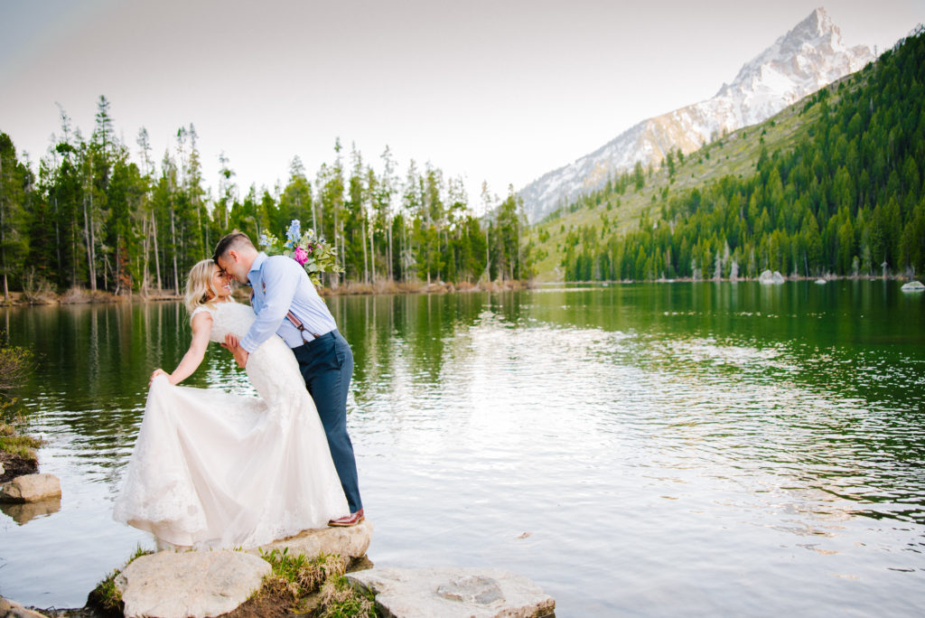 Jackson Hole wedding photographer captures bride and groom kissing 