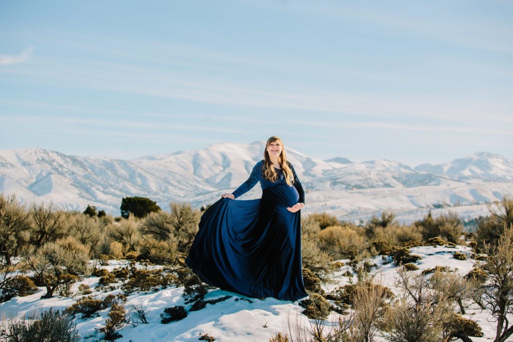 Jackson Hole wedding photographer captures woman wearing navy dress during maternity photos