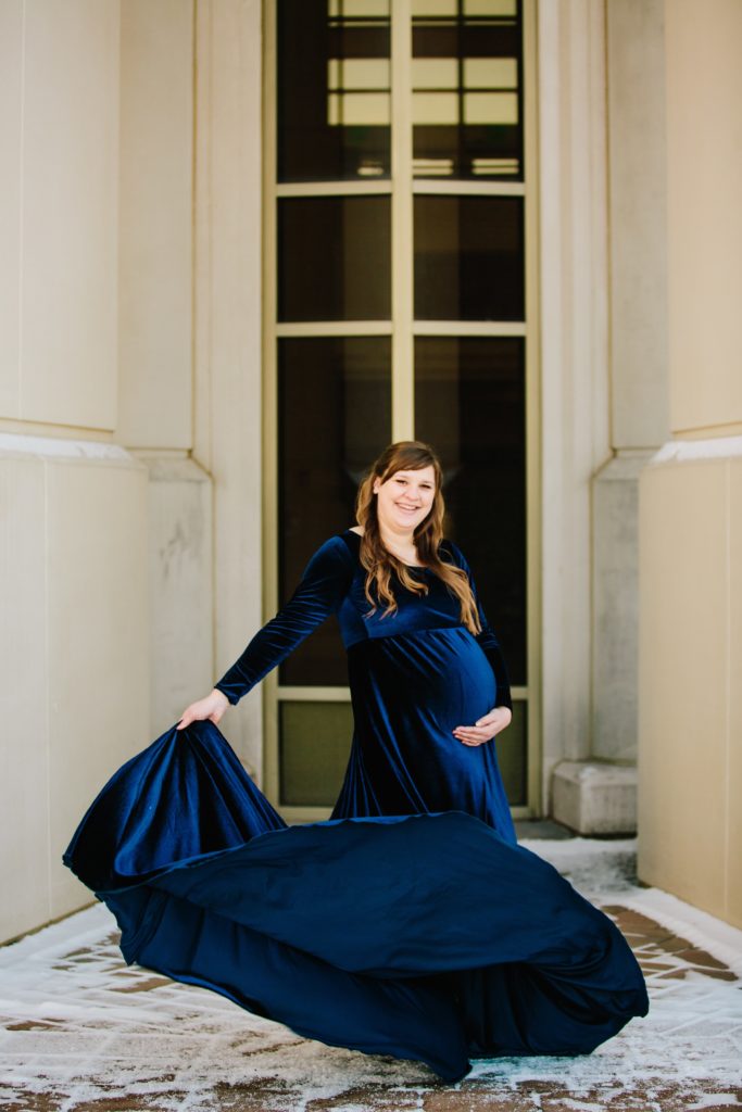 Jackson Hole wedding photographer captures woman twirling dress during maternity portraits