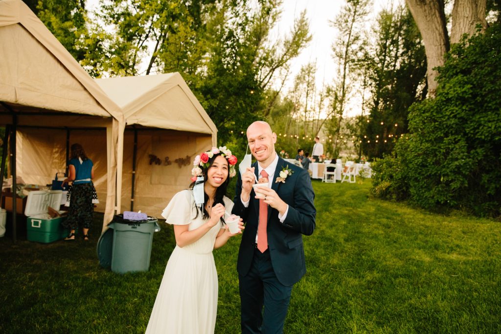 Jackson Hole wedding photographer captures bride and groom eating ice cream