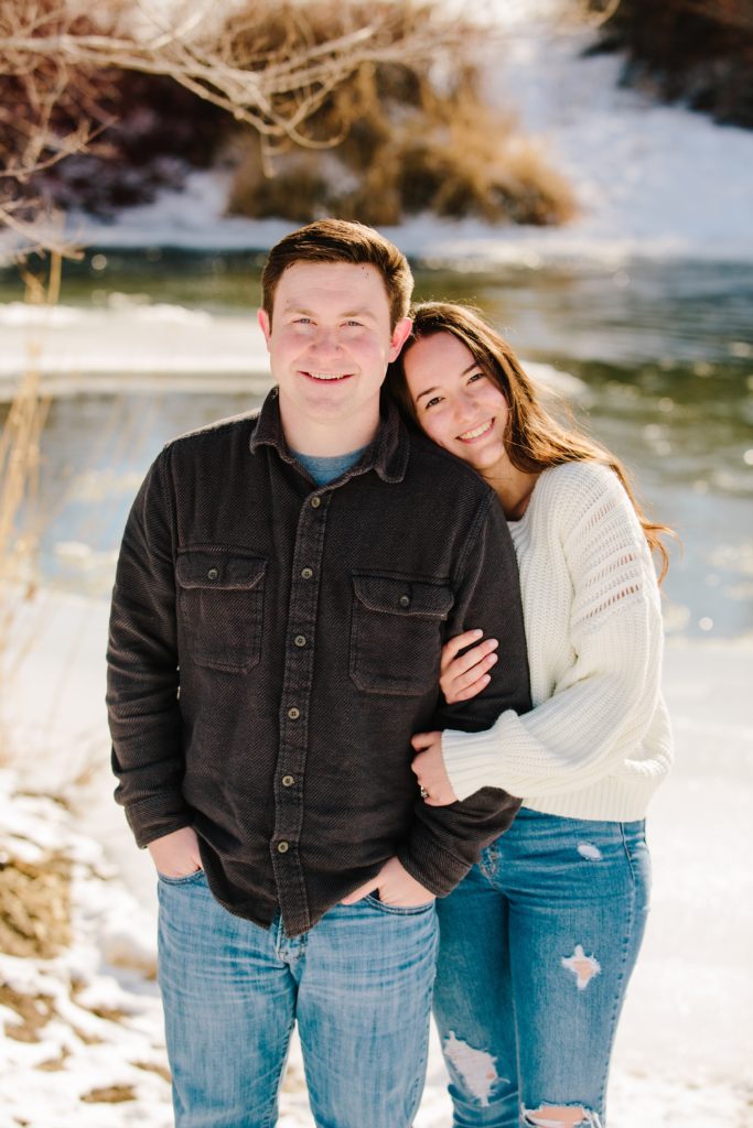 Jackson Hole wedding photographer captures man and woman embracing during snowy engagements