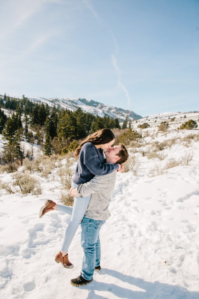 Jackson Hole wedding photographer captures man lifting woman up and kissing her