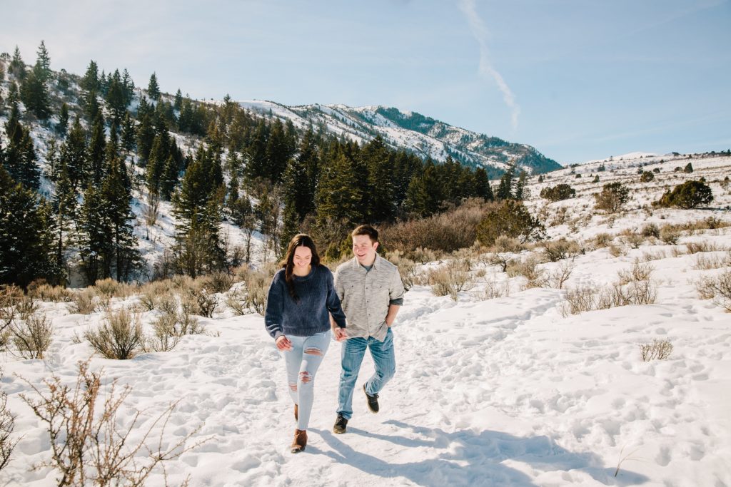 Jackson Hole wedding photographers capture couple walking through snow together