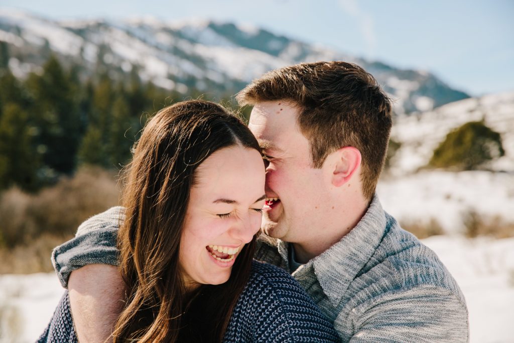 Jackson Hole wedding photographers capture newly engaged couple laughing