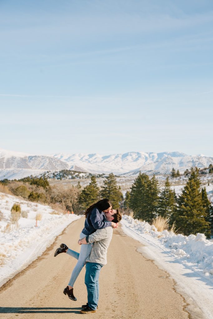 Jackson Hole wedding photographers capture man lifting woman during idaho engagements