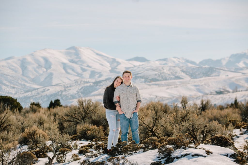 Jackson Hole wedding photographer captures couple hugging in front of snowy mountains