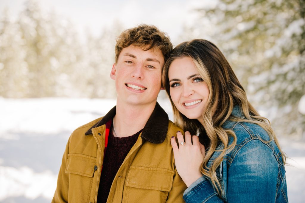 couple embracing and smiling together during engagements for Jackson Hole wedding