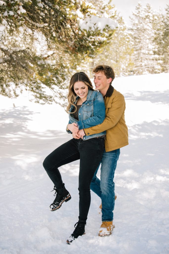 Jackson Hole wedding photographer captures man and woman laughing during engagements