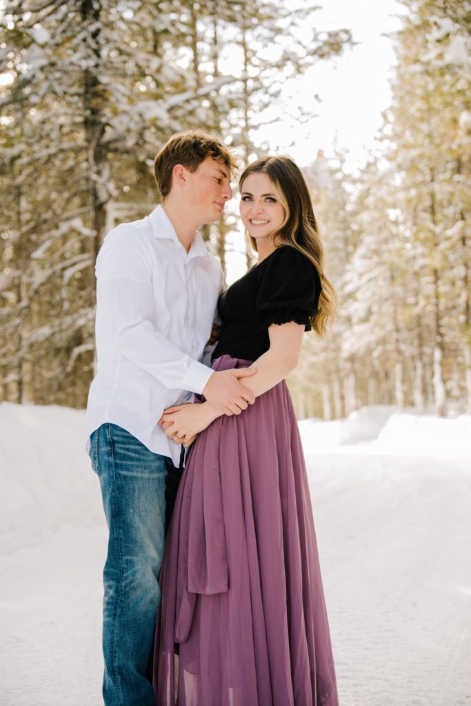 Jackson Hole wedding photographer captures woman wearing purple dress and man wearing white shirt
