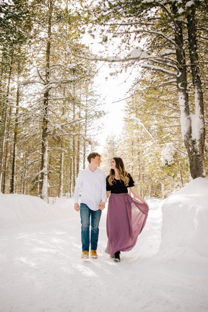 Jackson Hole wedding photographer captures couple walkng in Island Park Winter Wonderland