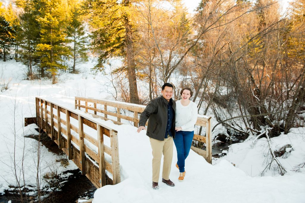 Jackson Hole wedding photographer captures Couple laughing in snowy engagements