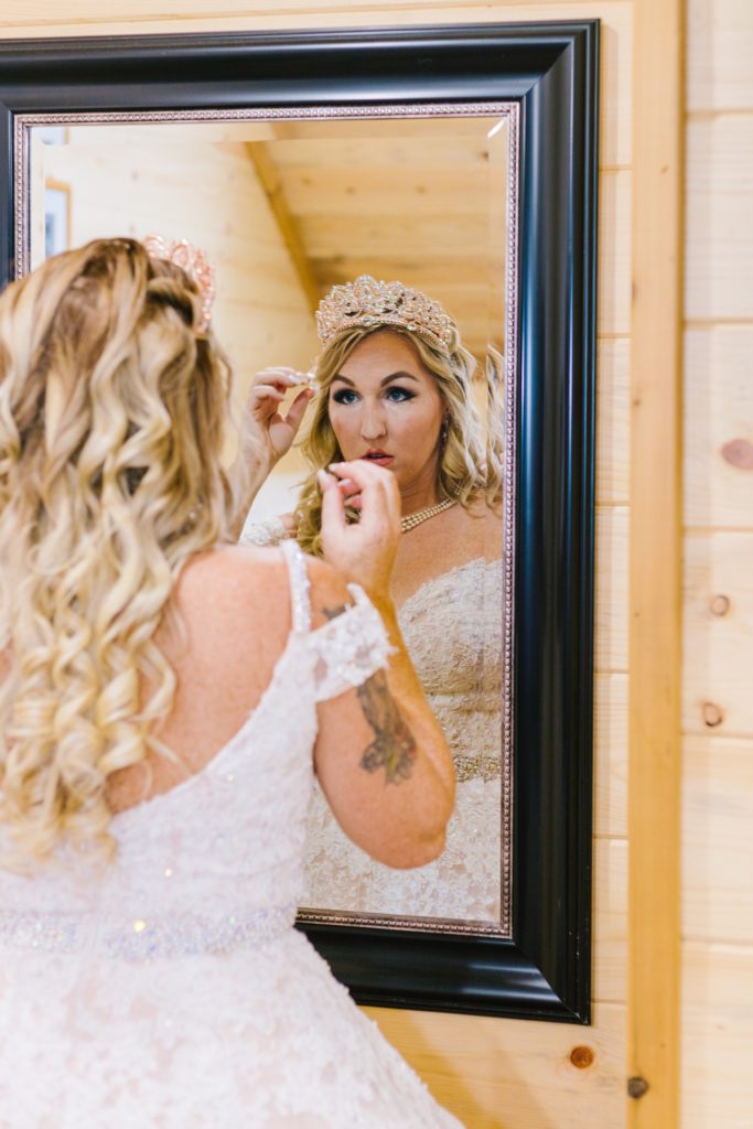 Jackson Hole wedding photographer caputres Bride getting ready in mirror