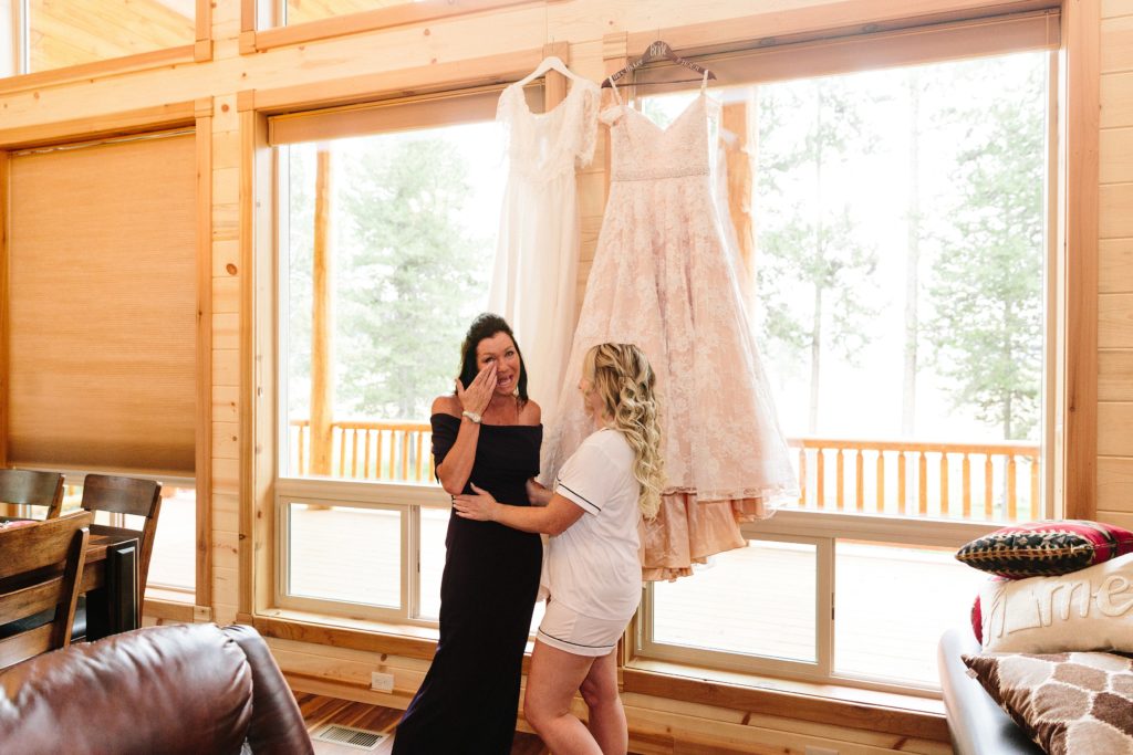 Jackson Hole wedding photographer captures daughter surprising mother with mothers wedding dress