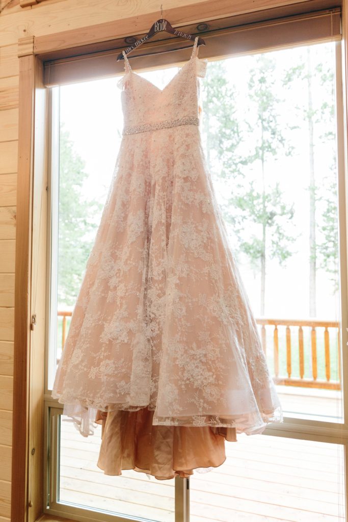 Jackson Hole wedding photographer captures wedding dress in window