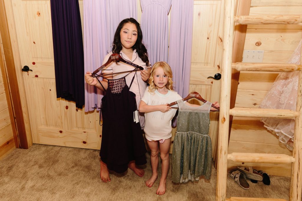 Jackson Hole wedding photographer captures young daughters holding dresses