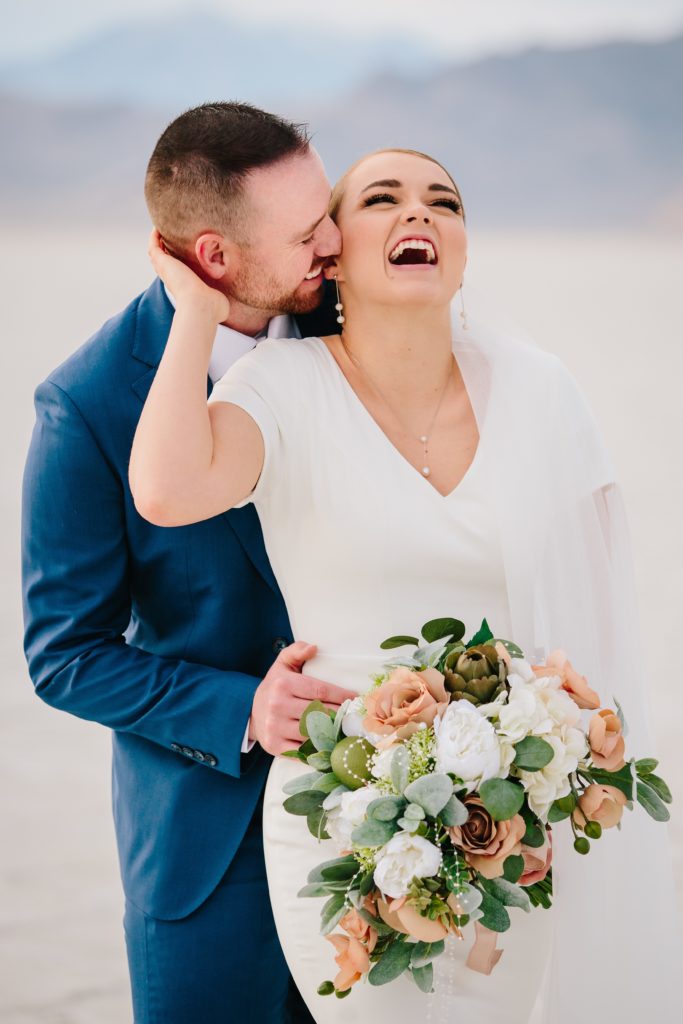 Jackson Hole wedding photographer captures Groom making bride laugh Dreamy Bonneville Salt Flats Sunset Bridal Wedding Photography