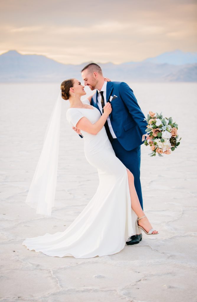 Jackson Hole wedding photographer captures bride and groom hugging during sunset bridals
