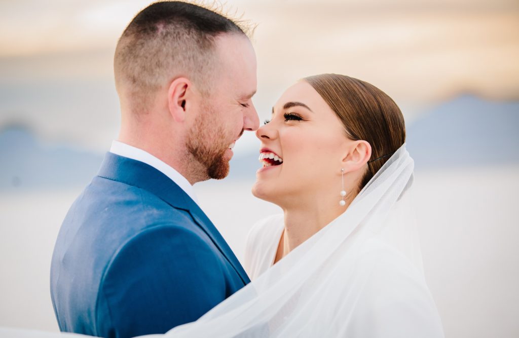 Jackson Hole wedding photographer captures Bride and groom snuggle noses and laugh