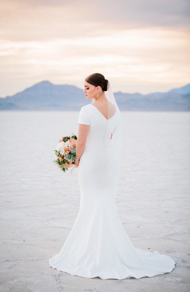Jackson Hole wedding photographer captures back details of bride's dress at salt flats in utah
