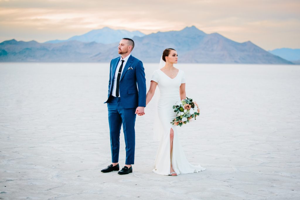 Jackson Hole wedding photographer captures couple looking in opposite directions utah wedding salt flats