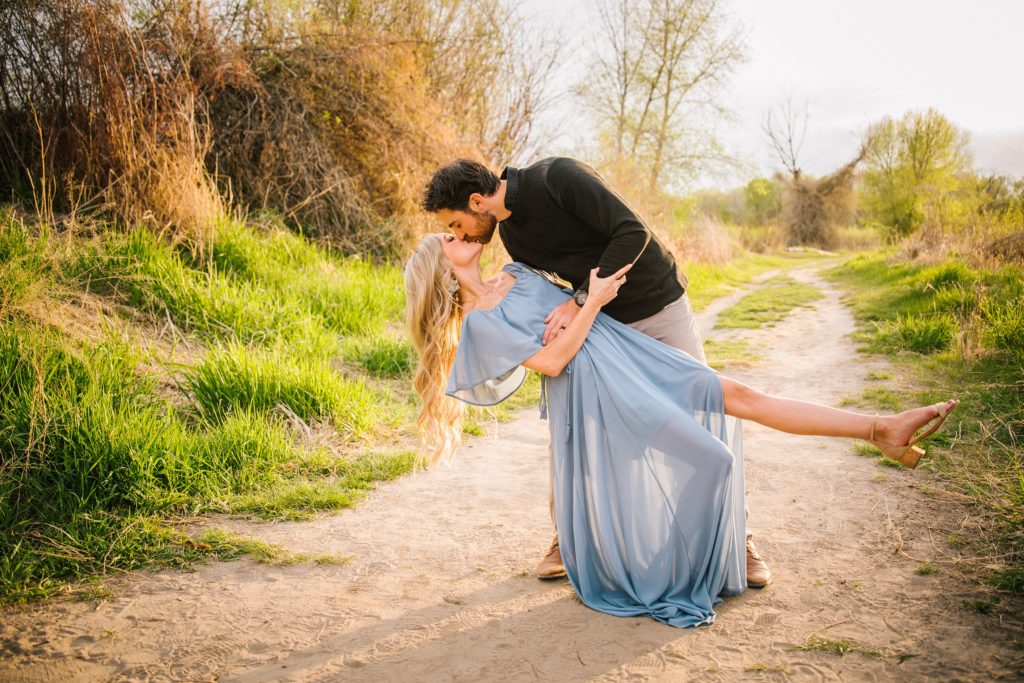 Jackson Hole wedding photographer captures dip and leg kicked out kiss at sunset