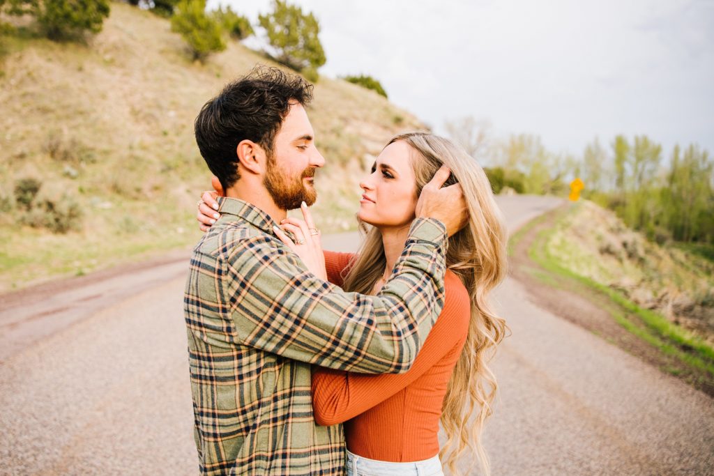 Jackson Hole wedding photographer captures man brushing womans hair away before kiss 