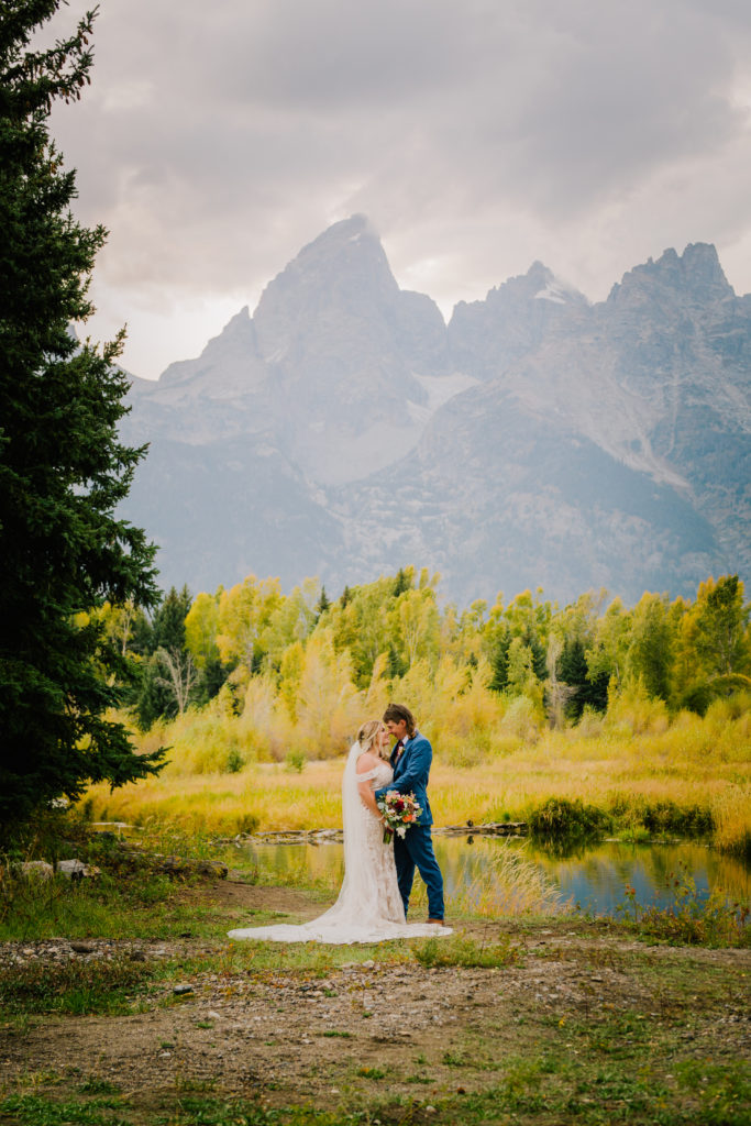 Jackson Hole wedding photographer captures Bride and groom kissing in grand Teton national park after they elope in Jackson hole