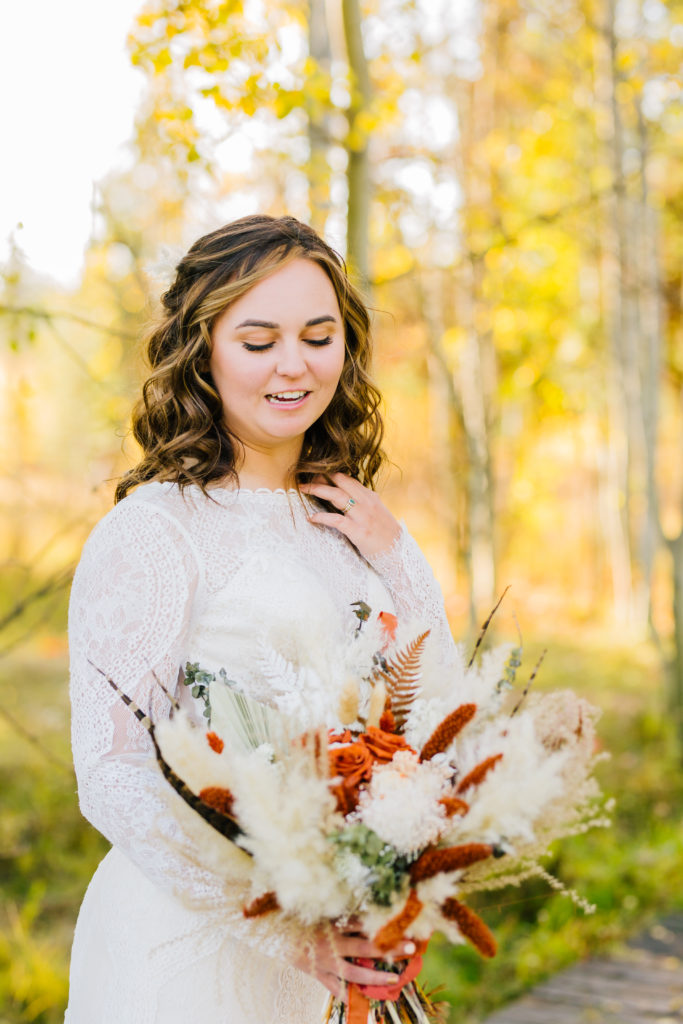 bride holding rust and cream flower bridal bouquet