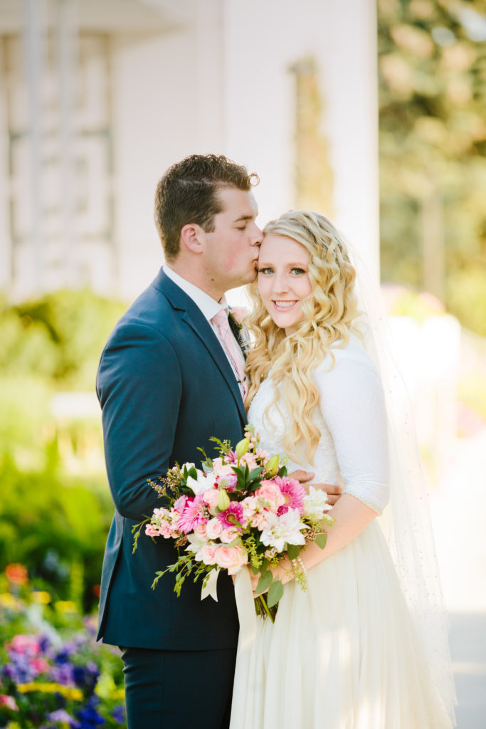 bride and groom on wedding day with pink bouquet