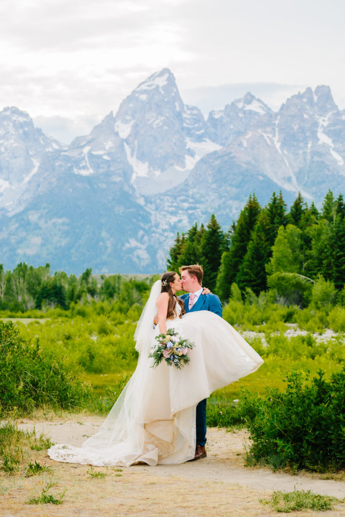 Jackson Hole wedding photographer captures groom lifting bride in Grand Teton National Park