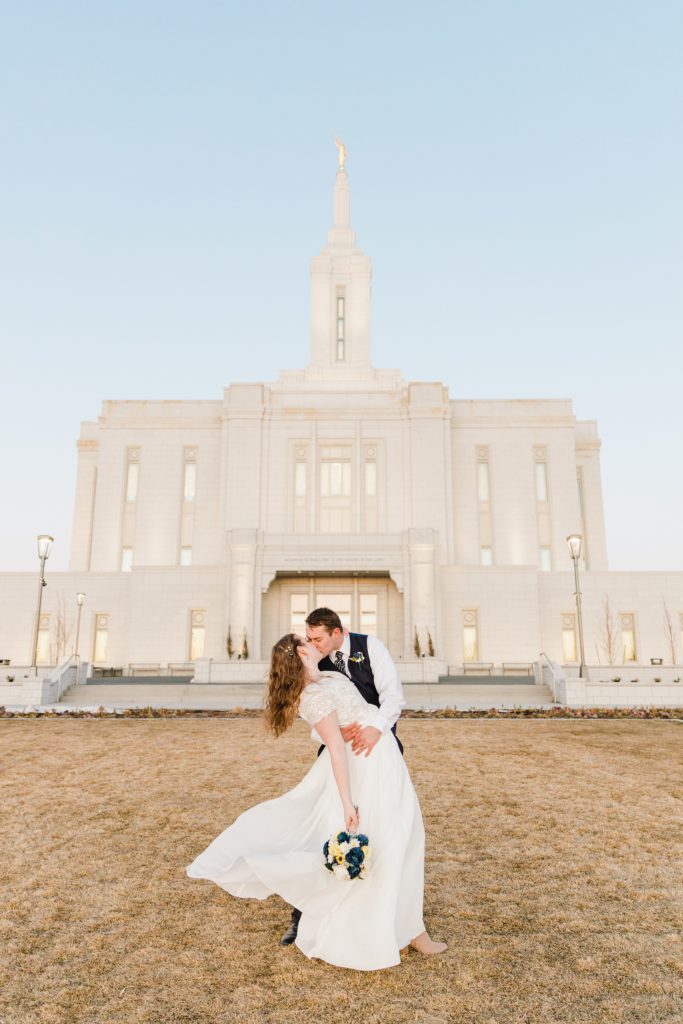 Jackson Hole wedding photographer captures Bride dress flutters in wind Chilly Pocatello Temple Bridals