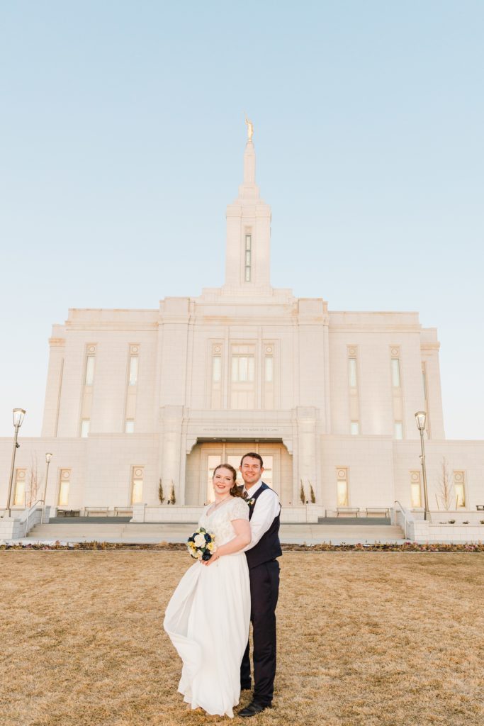 Jackson Hole wedding photographer captures Bride and groom stand in front of LDS pocatello temple