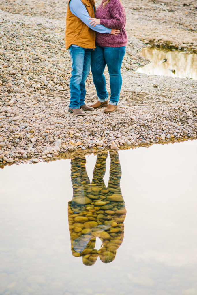 Jackson Hole wedding photographer captures Couple's reflection in water during fall engagement session 