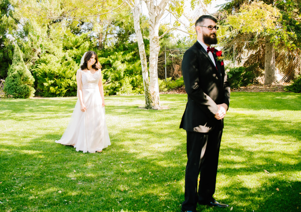 Jackson Hole wedding photographer captures Dress reveal in backyard  Idaho Wedding couple