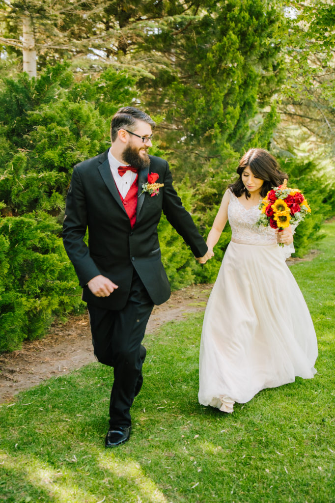 Jackson Hole wedding photographer captures Bride and groom running away in love