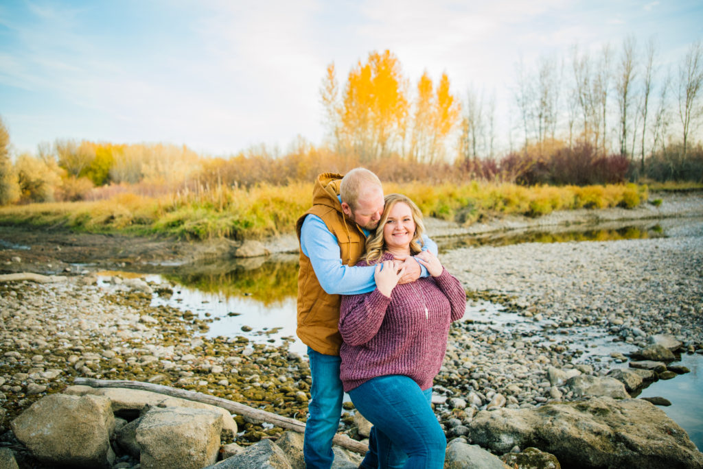 Jackson Hole wedding photographer captures couple wearing warm clothes during fall engagement session