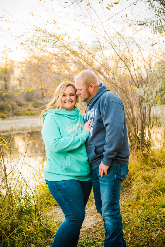 Jackson Hole wedding photographer captures Man looking down at woman during fall engagement session