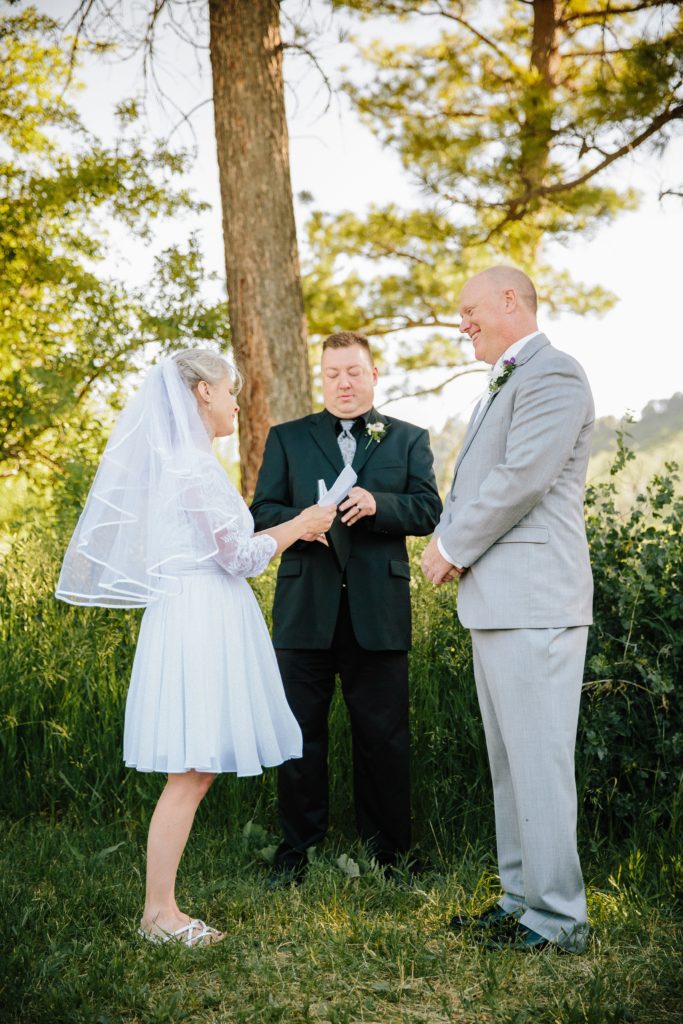 Jackson Hole wedding photographer captures bride reading vows at outdoor pocatello wedding venue