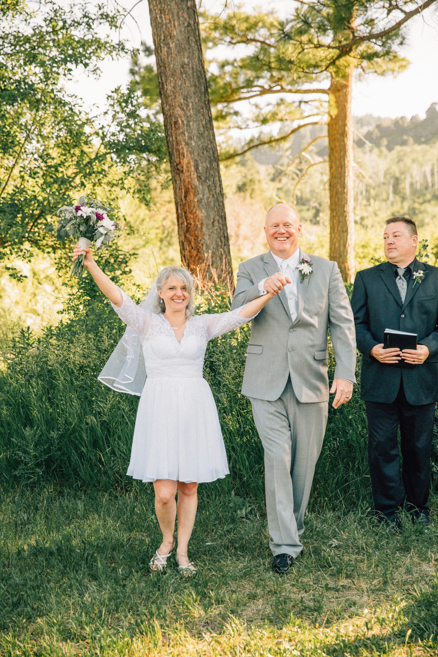 Jackson Hole wedding photographer captures bride celebrates as they are declared husband and wife outdoor pocatello wedding venue