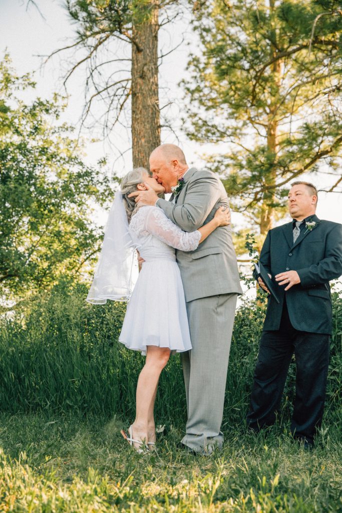 Jackson Hole wedding photographer captures first kiss outdoor pocatello wedding venue