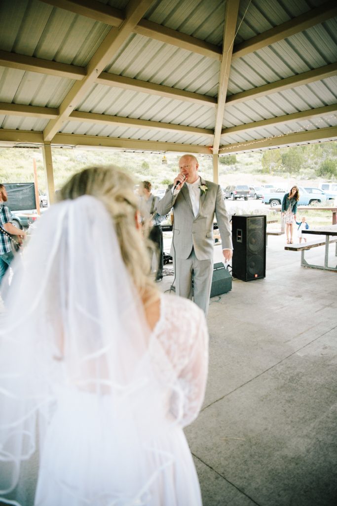 Jackson Hole wedding photographer captures groom singing song to bride