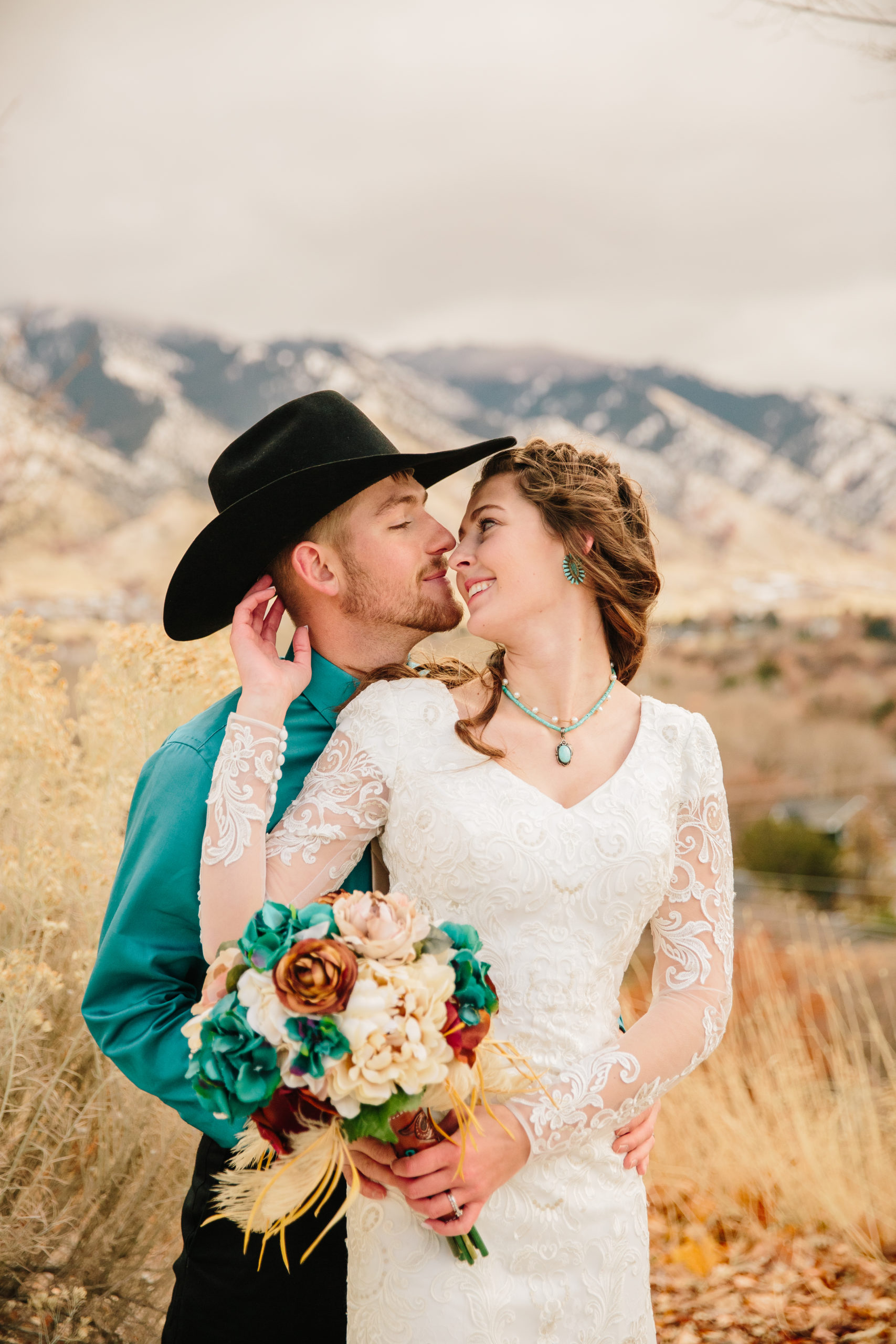fall wedding inspiration with bride and groom leaning into each other with the mountains behind them