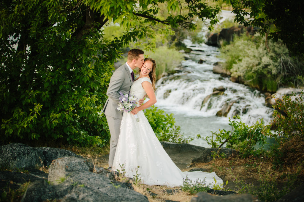 bride and groom embracing at golden falls during outdoor bridals